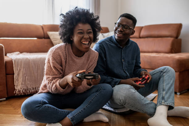 istock Couple at home having fun and playing video games 1321674120