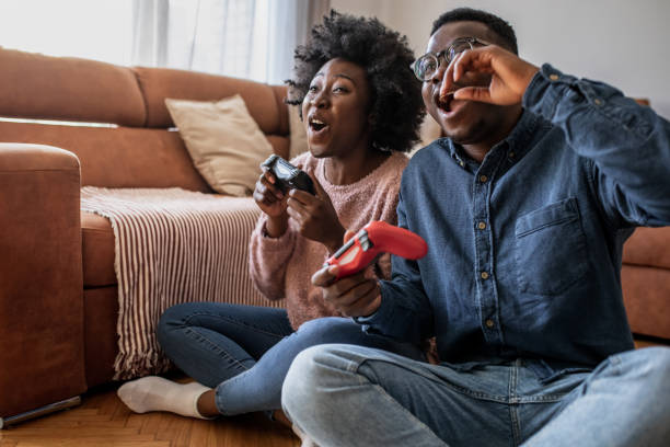 istock Couple at home having fun and playing video games 1321674193