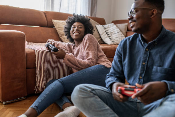 istock Couple at home having fun and playing video games 1321674194