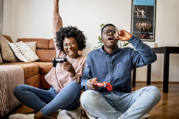 istock Couple at home having fun and playing video games 1321675465