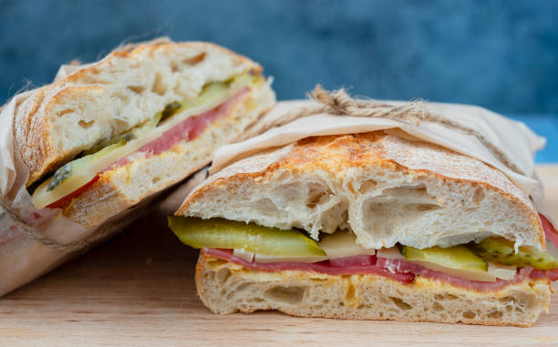 grilled cuban sandwich with pickles, cheese and ham, close-up - portion cheese baguette bread imagens e fotografias de stock