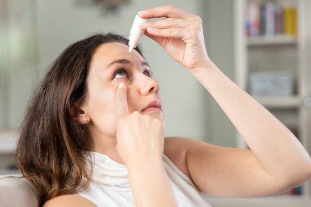 istock Young woman putting eye drops 1321677192