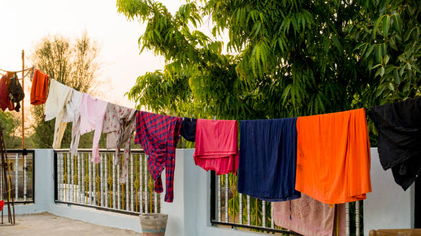Washed clothes hanging on the roof of the building. Roof terrace of the building in the city. stock photo