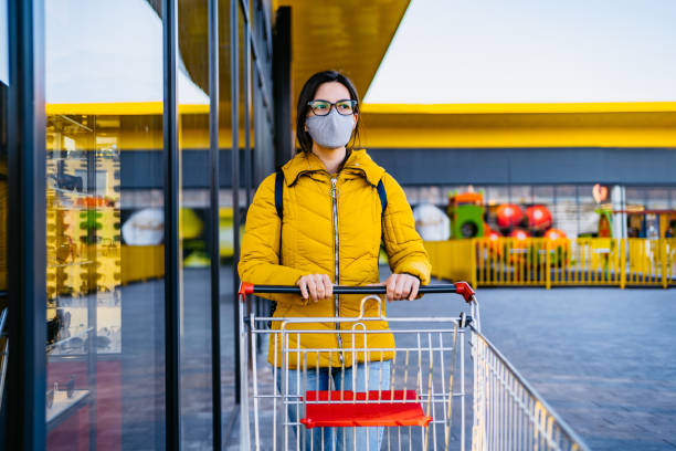 istock Woman in grocery store with face mask 1321682126