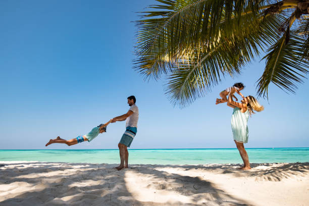 istock Playful parents having fun with their kids on the beach. 1321683968