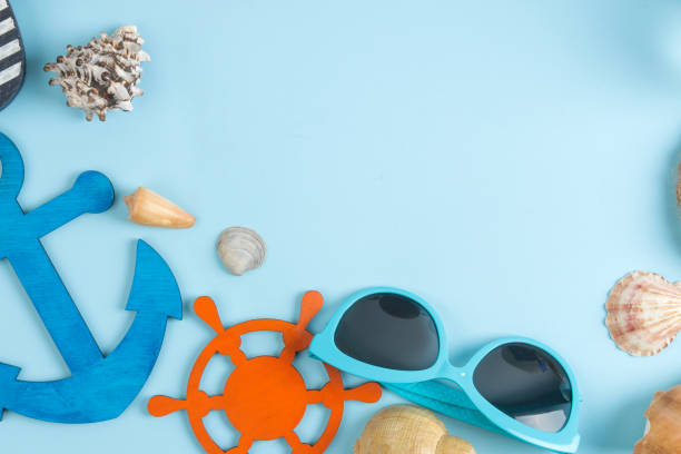 istock summer accessories with sun glasses and shells, on a bright blue background. free space. top view. frame 1321684180