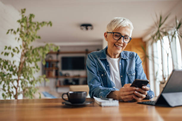 istock Senior woman, messaging her husband, from home office. 1321685208