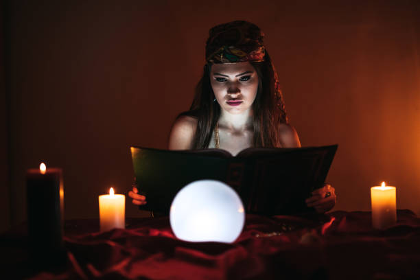 istock Fortune teller and book of charms 1321687313