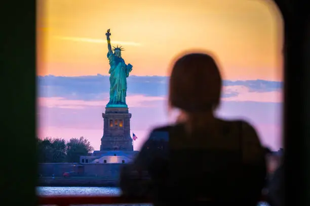 Photo of Woman watches the Statue of Liberty