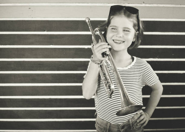 istock The girl with his old trumpet 1321691464