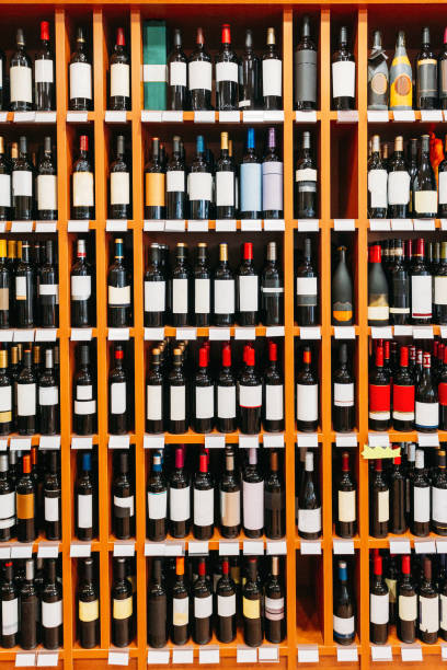 istock Showcase With Wine Bottles At The Wine Store. Wall With Alcoholic Drinks Wine Bottles On Shelves 1321694615