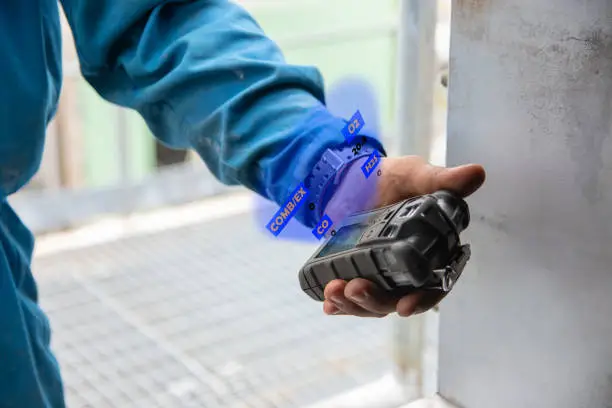 Photo of Human's hand holding the Portable Gas Detector.