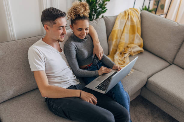 istock Couple using laptop together at home 1321699176