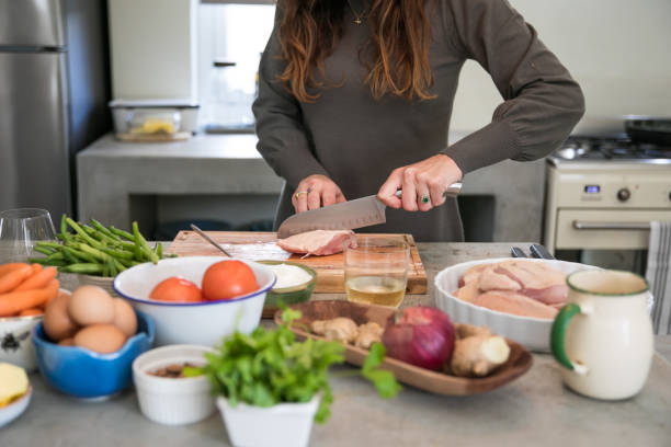 istock Women in kitchen preparing food 1321699801