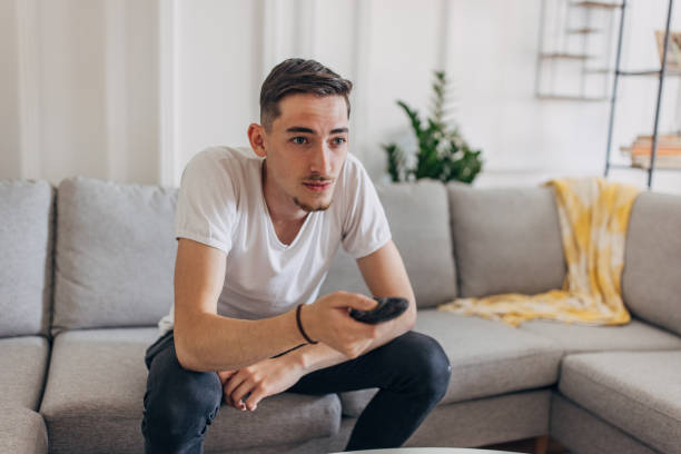 istock Man watching TV at home 1321700399