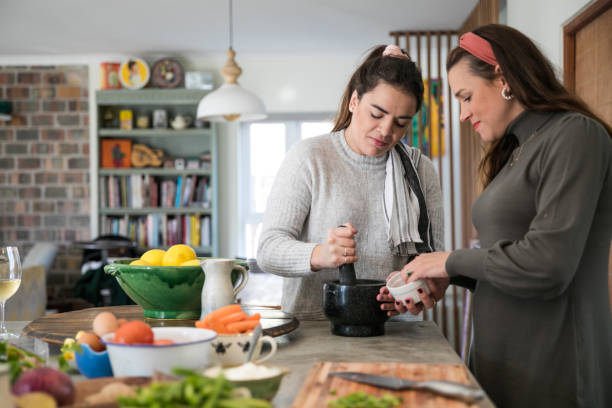 istock Women in kitchen preparing food 1321701506