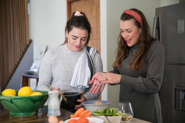 istock Women in kitchen preparing food 1321702375