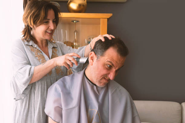 istock Couple enjoying cutting hair at home during COVID-19 quarantine 1321704861