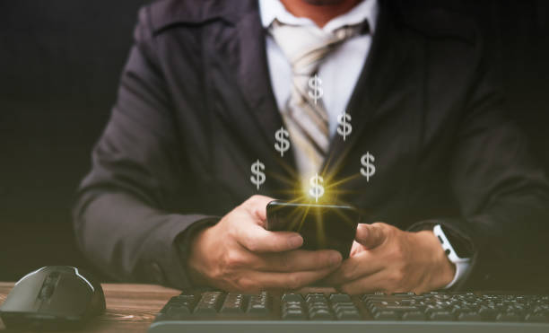 istock Businessman using a mobile phone and money concept 1321704926