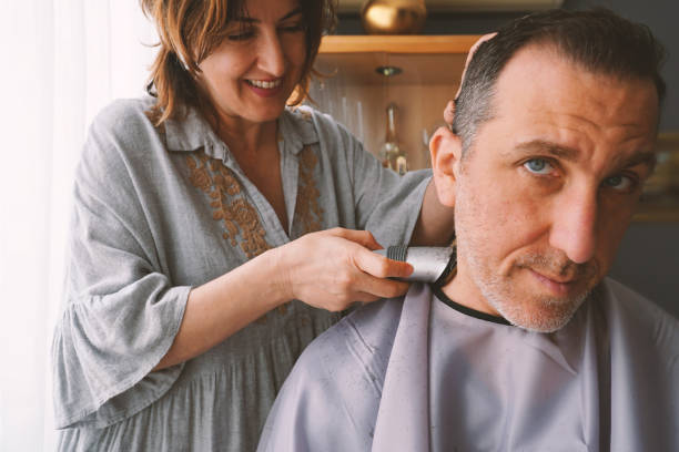 istock Couple enjoying cutting hair at home during COVID-19 quarantine 1321705013