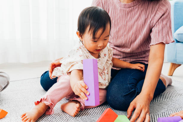 istock Mother playing at home with baby 1321705998