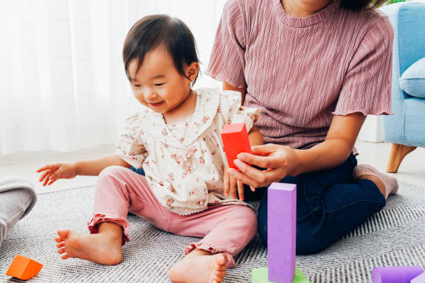 istock Mother playing at home with baby 1321706000