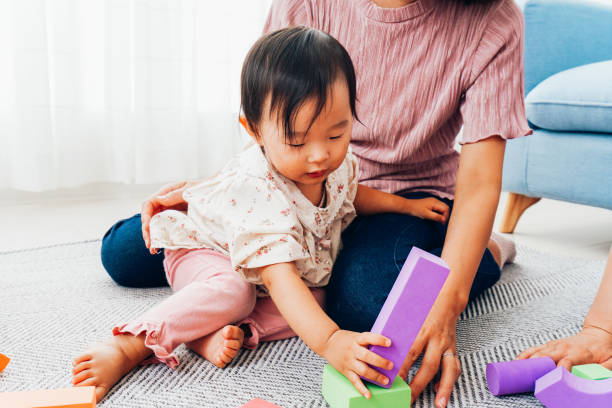 istock Mother playing at home with baby 1321706009
