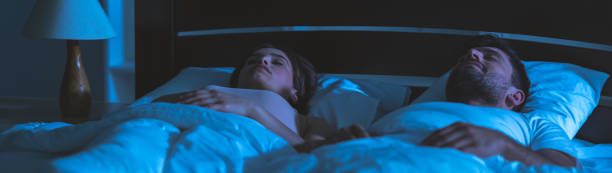 istock The man and woman sleeping in the comfortable bed. night time 1321706526
