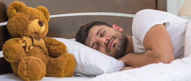 istock The man sleeping near the soft toy 1321706682