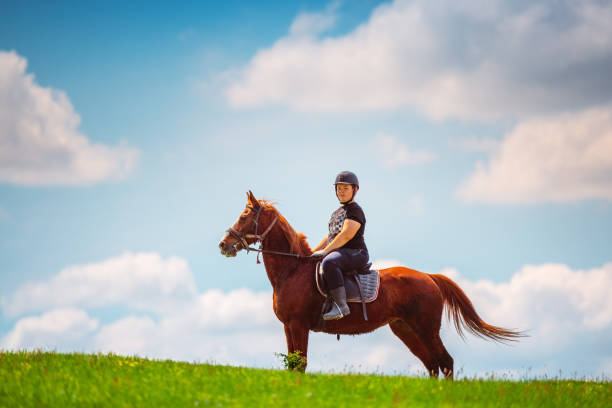 istock Young Boy riding a horse in the field 1321707710