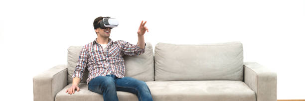 istock The man in virtual glasses sitting on the sofa on the white wall background 1321708051