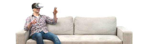 istock The man in virtual glasses gesturing on the sofa on the white wall background 1321708119