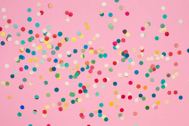 istock multicolored paper confetti on pink isolated background 1321708403