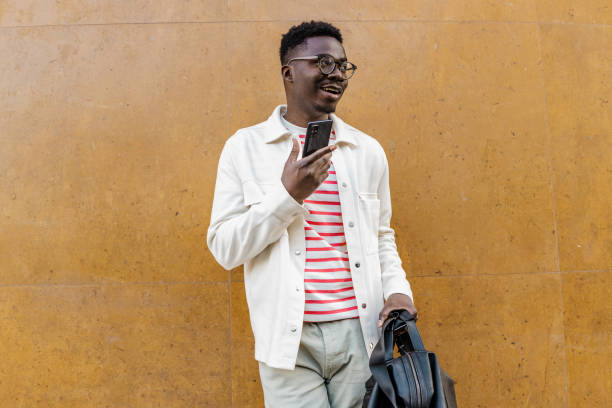 istock Smiling young African-American using mobile phone 1321709813
