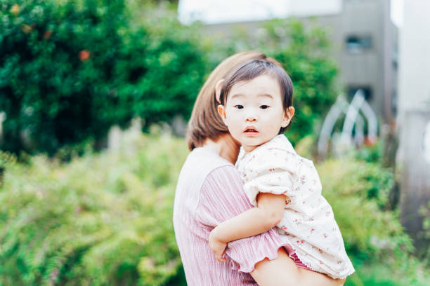 istock Mother playing in the park with her baby 1321709842