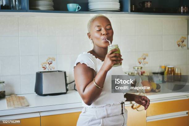 Young African Woman Enjoying A Smoothie Using A Metal Straw Stock Photo - Download Image Now