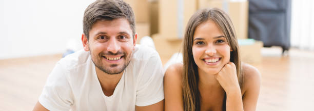 istock The happy couple lay on the carpet 1321710358