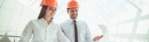 istock The two engineers hold the project plan in the building 1321711552
