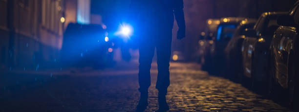 istock The man with a flashlight stand on wet road. Evening night time 1321712024