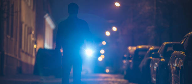 istock The man with a flashlight inspect the street. Evening night time 1321712045