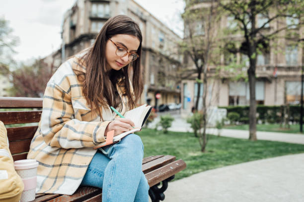istock Beautiful student studying in the park 1321712181