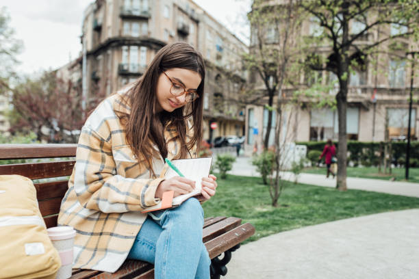 istock Beautiful student preparing her exam in the park 1321712188