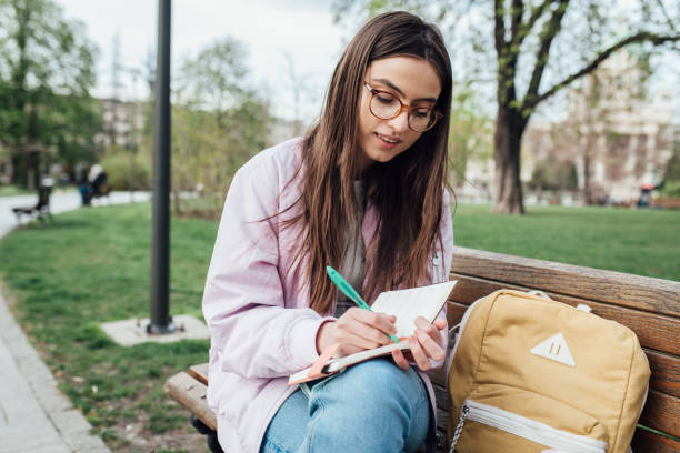 istock Beautiful student learning for the exam and enjoying in the park 1321712197