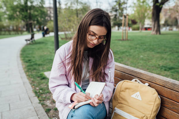 istock Portrait of a beautiful student studying in the park 1321712201