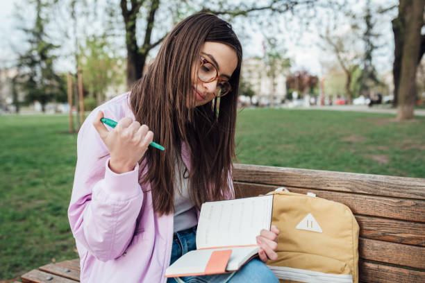 istock Beautiful student learning and relaxing in the park 1321712209