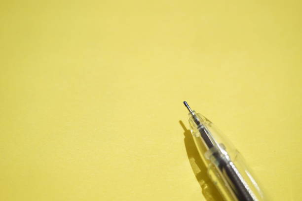istock Ball pen on a sunny yellow paper 1321712393