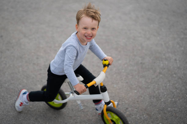 istock cheeful little boy on his walking bike 1321712966