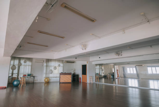istock empty dance studio with wooden flooring, window ,barre and mirror 1321713529