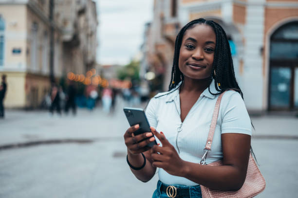 istock Cheerful african american woman using smartphone 1321722247