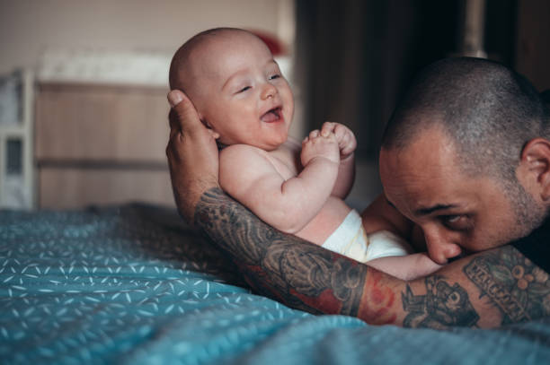 istock Tattooed bearded father playing with his son 1321722265